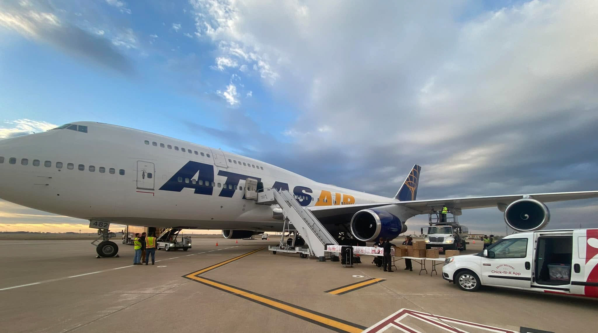 ATLAS cargo aircraft on the LBB ramp. Stairs are next to the aircraft, and there is a van parked next to the wing.