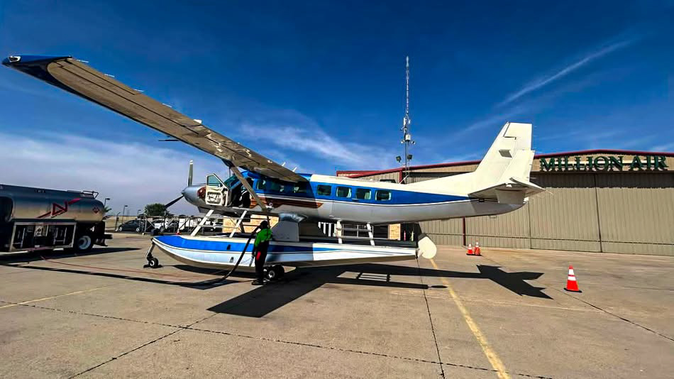 Float plane parked on the LBB ramp with a fuel truck. Hangar with Million Air sign is in the background